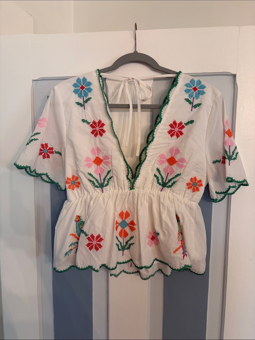 Eloise Top- White Embroidered Peplum Blouse with Floral and Parrot Motif - Picture 2 of 3